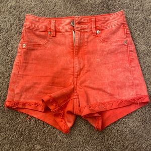 High-rise red shorts.